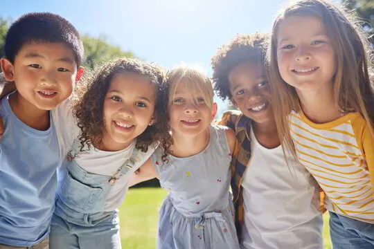 Children smiling together and enjoying healthy, happy smiles