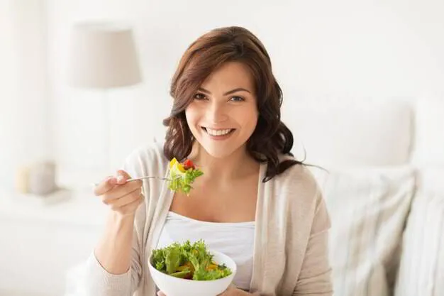 Woman enjoying a healthy salad with a bright, confident smile