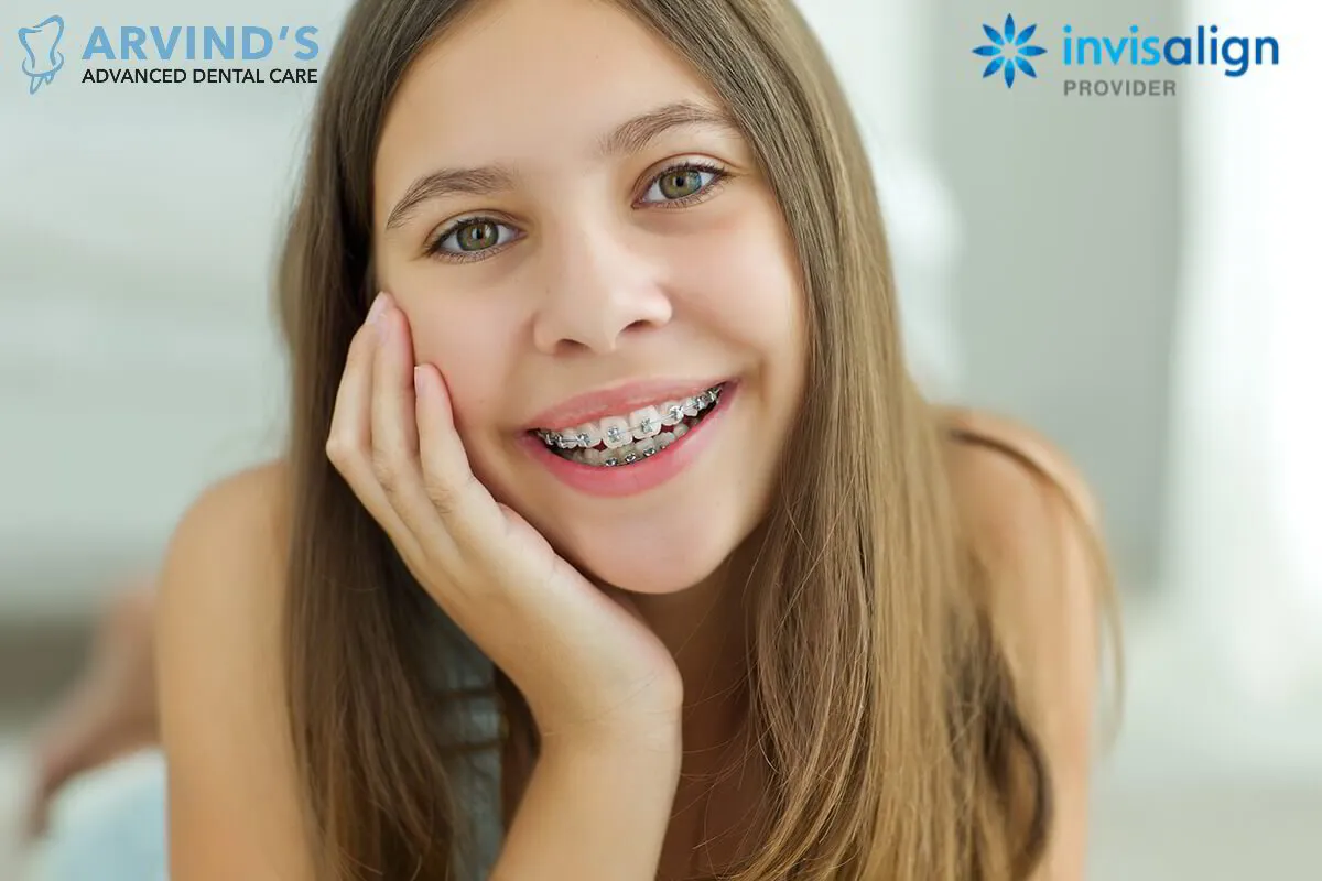 Young woman smiling with traditional metal braces on her teeth