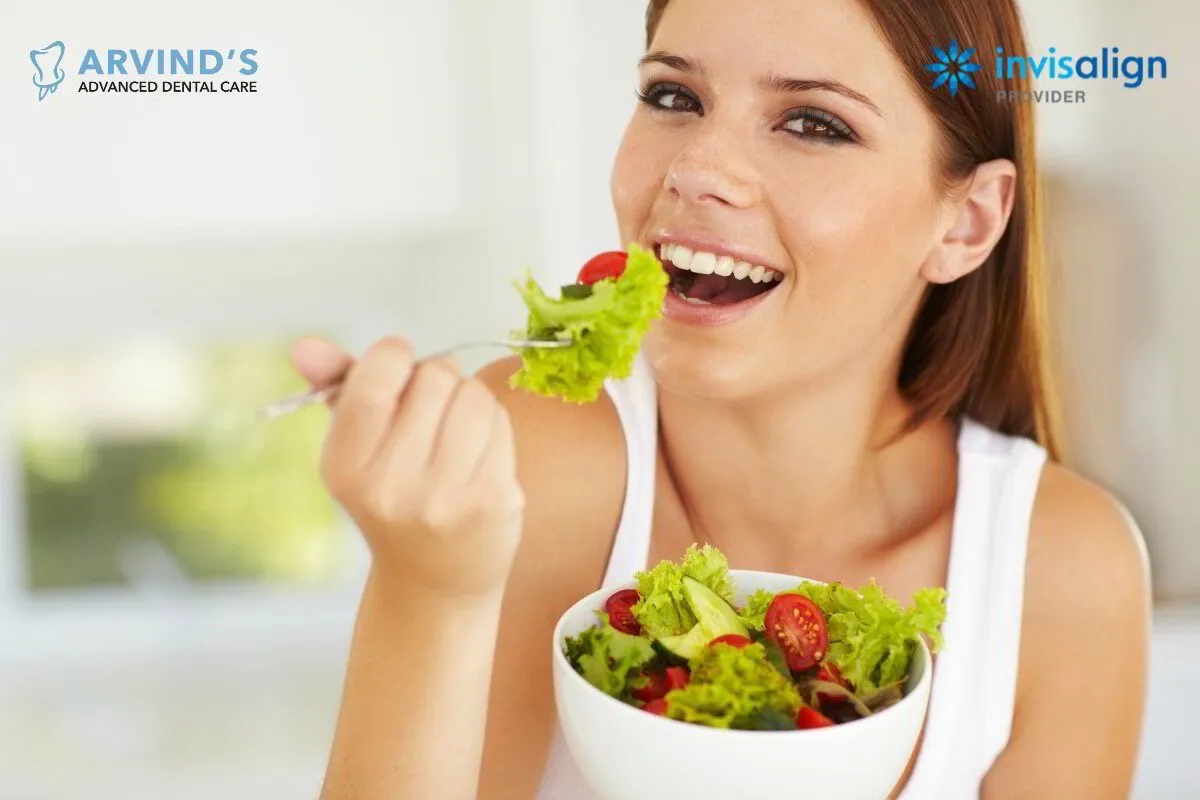 Woman enjoying a healthy meal with a bright smile at Arvind's Advanced Dental Care