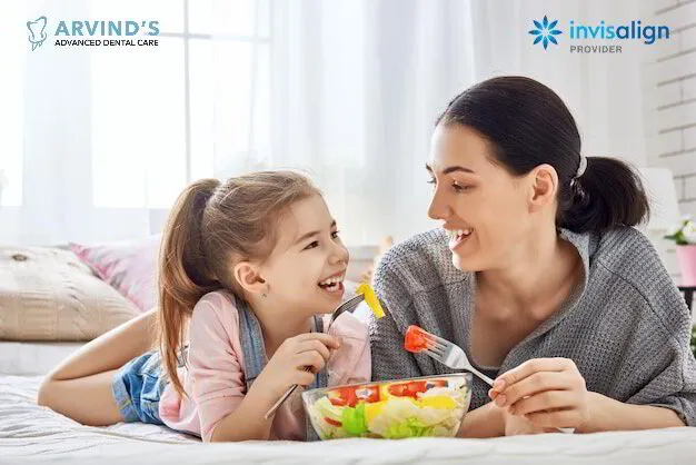 Mother and daughter enjoying a meal while promoting healthy smiles at Arvind's Advanced Dental Care