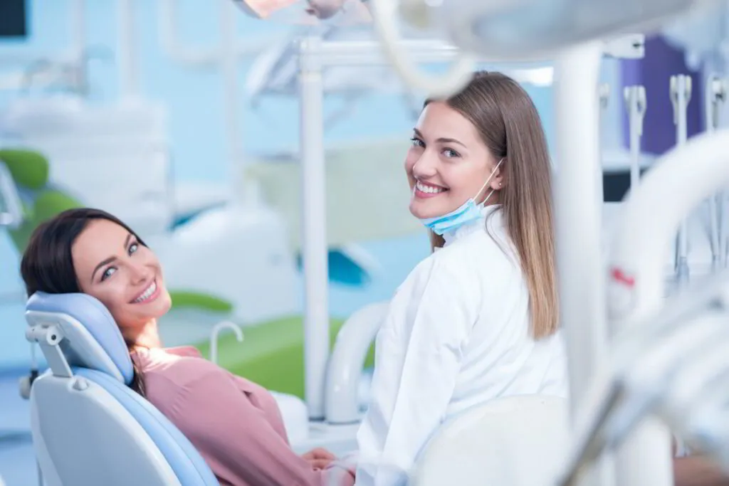 Dentist providing professional dental treatment to a smiling patient in a modern clinic