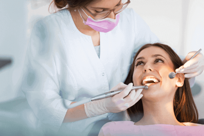 Dentist performing a dental examination and treatment on a patient