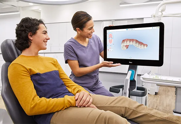 Dentist explaining a 3D digital dental scan to a patient during a consultation