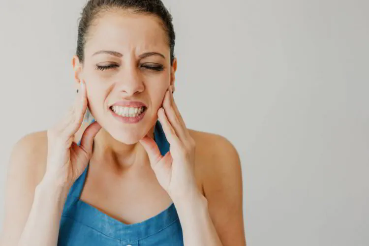Woman experiencing severe tooth and jaw pain